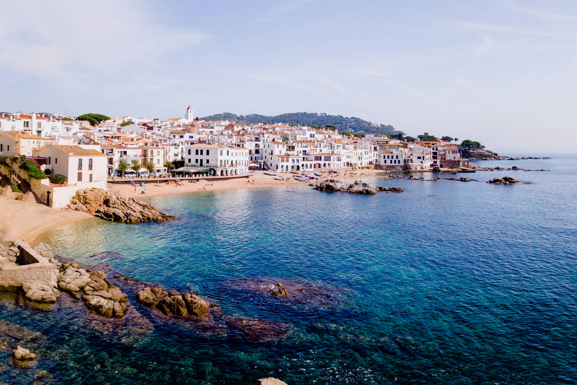 Calella de Palafrugell, nice aerial view of the Costa Brava on the beach with tourists summering.