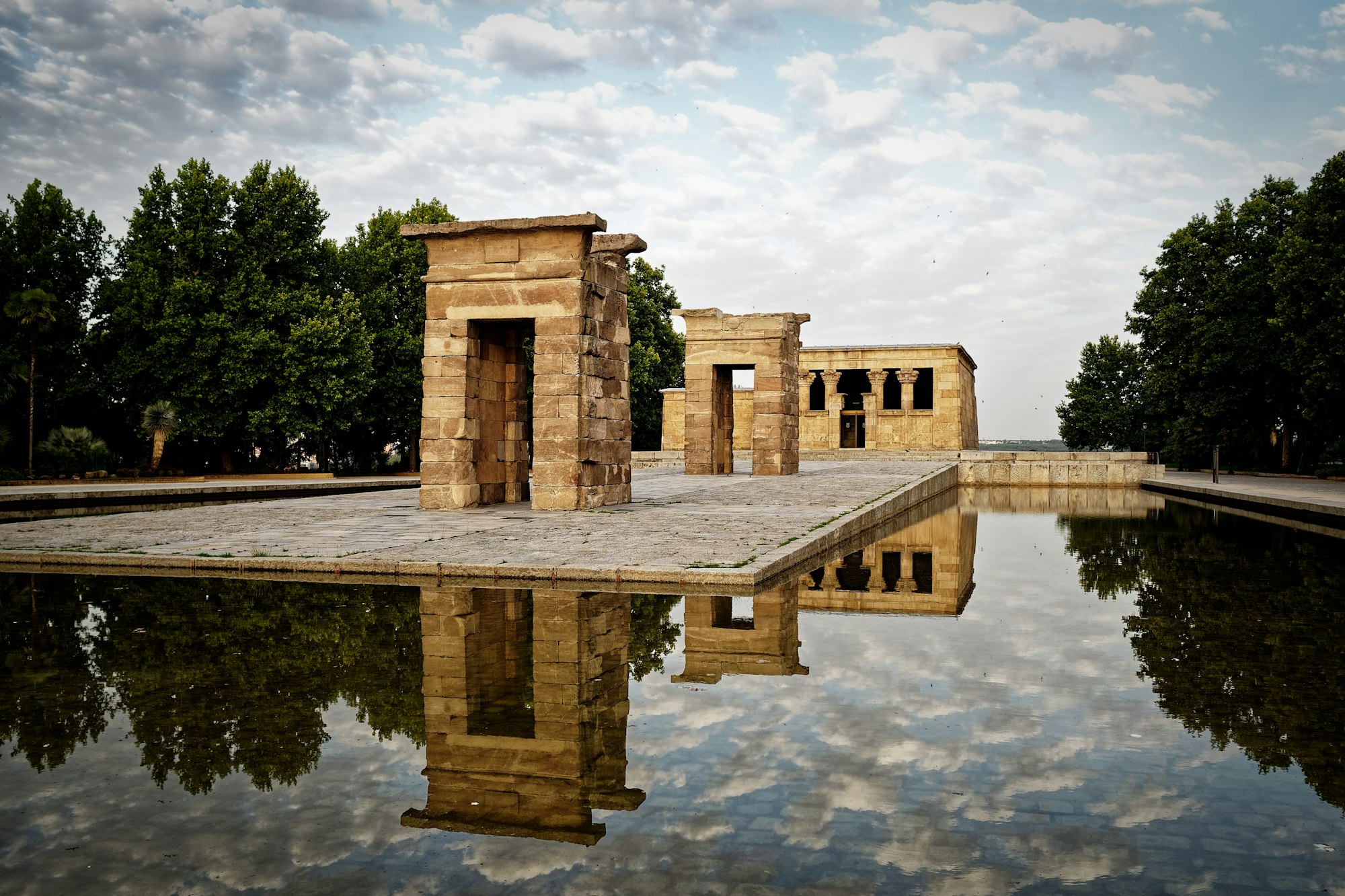 Debod Egyptian temple in Madrid, Spain with clouds reflected in the pond