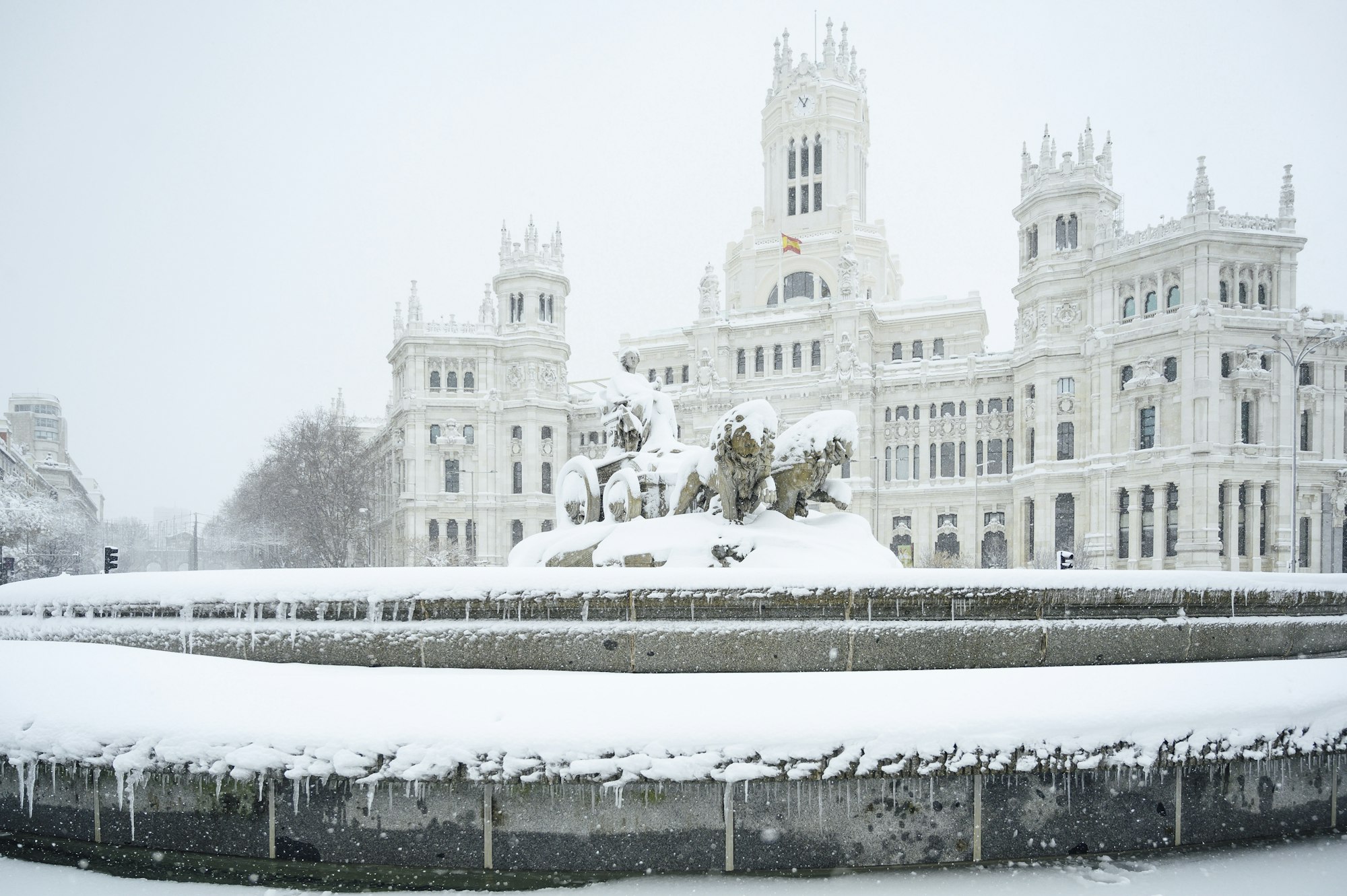 Fountain of the Plaza de Cibeles in Madrid covered with snow after the passage of the storm Filomena