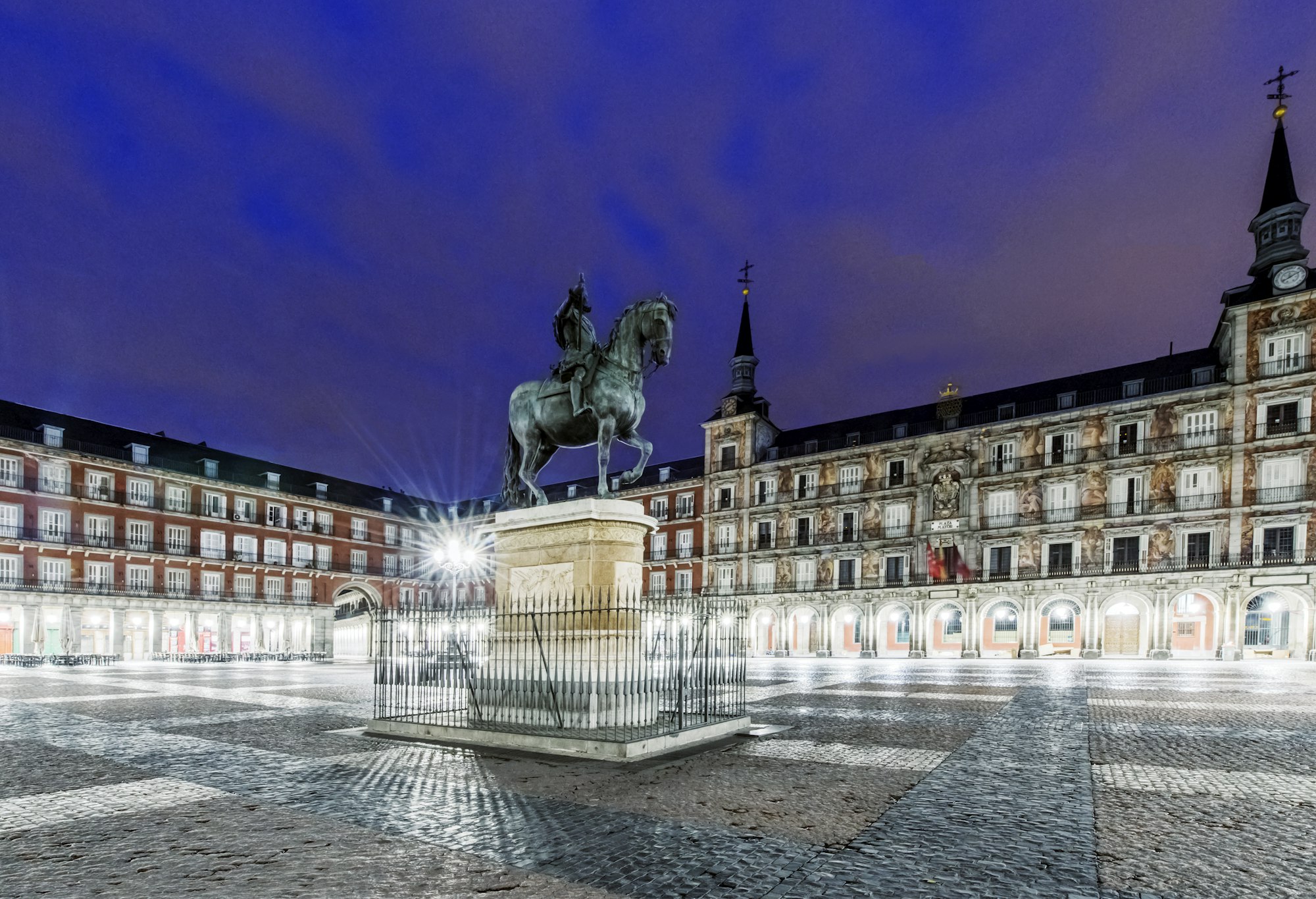 Ornate building and statue illuminated at night, Madrid, Madrid, Spain