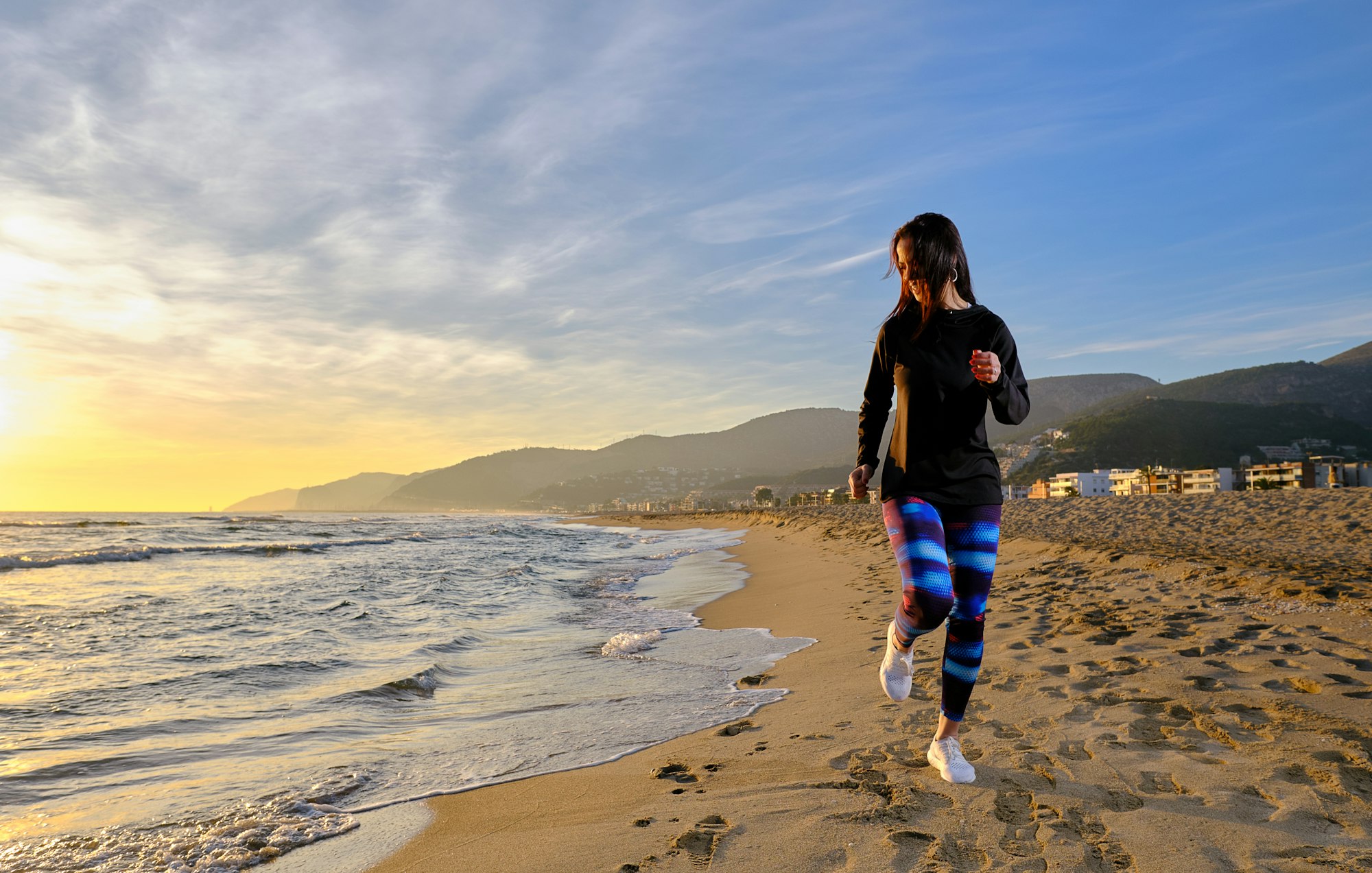 Sporty woman running near sea